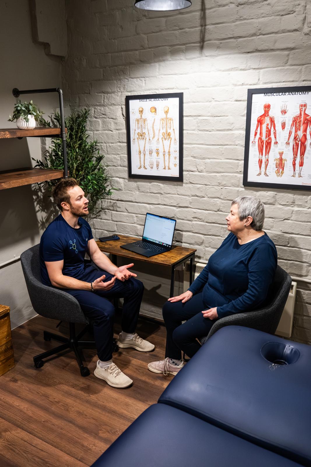 KA3_4223 Practitioner and patient reviewing clinical biometric data and long-term health goals during a private consultation in our Edinburgh facility.